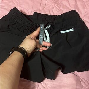 Vuori Black Women's Athletic Shorts with White Zip Accent